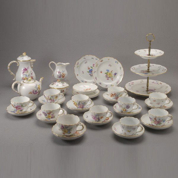 Meissen Porcelain Tea & Coffee Service: Meissen Porcelain Tea and Coffee Service: a coffee pot (height 8 inches); a teapot; a creamer; a covered sugar; ten tea cups and eleven saucers; one slightly larger cup and saucer; a three tier cake s