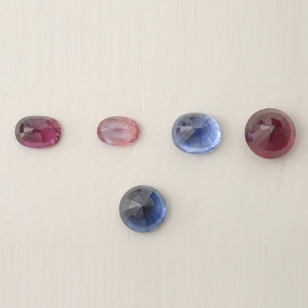 COLLECTION OF FIVE UNMOUNTED SAPPHIRES AND RUBIES.: COLLECTION OF FIVE UNMOUNTED SAPPHIRES AND RUBIES. Including one oval-cut sapphire weighing 0.42 ct.; one round-cut sapphire weighing approximately 1.26 ct.; one oval-cut sapphire weighing approximate