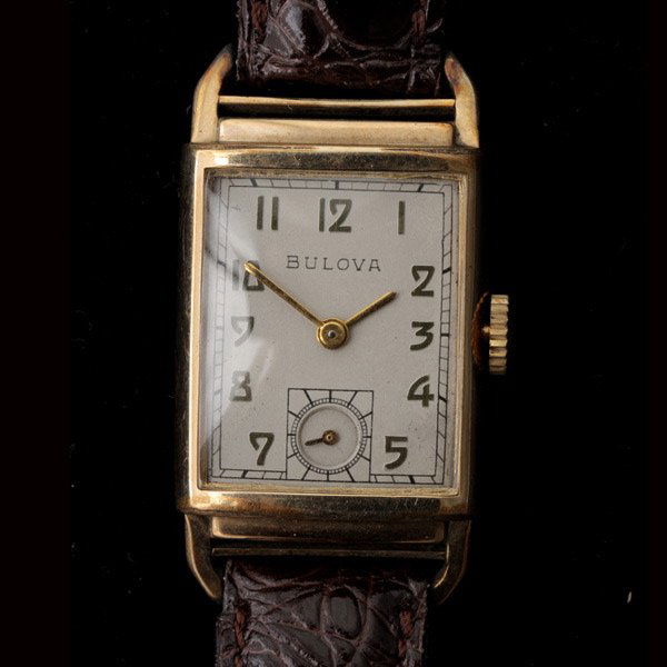 BULOVA 10K, GOLD-FILLED WRISTWATCH.: BULOVA 10K, GOLD-FILLED WRISTWATCH. DIAL: Rectangular, silvered, applied gold Arabic numeral hour markers, outer minutes track, sunken subsidiary seconds dial at 6 o'clock, gold baton hands, Bulova. M