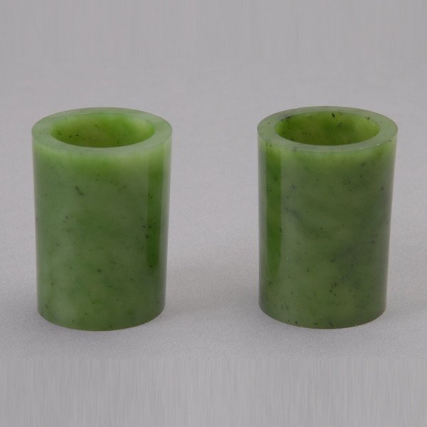Two Spinach Jade Scroll Ends: Two Spinach Jade Scroll Ends, both of cylindrical form {Height: 2 1/4 inches (5.7 cm)} [Small nicks]