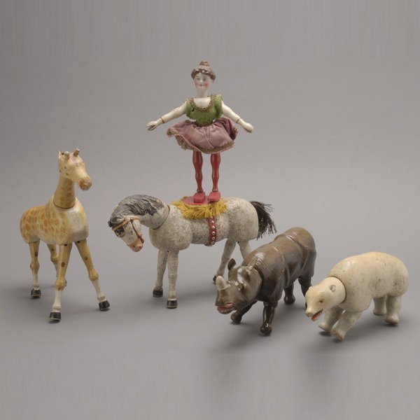 Schoenhut Circus Grouping (11): Schoenhut Circus Grouping: including Buffalo Bill; rhinoceros; zebra; polar bear; two clowns; two donkeys; giraffe; two horses, one surmounted with a bisque headed female rider (11) {Height of Buffalo