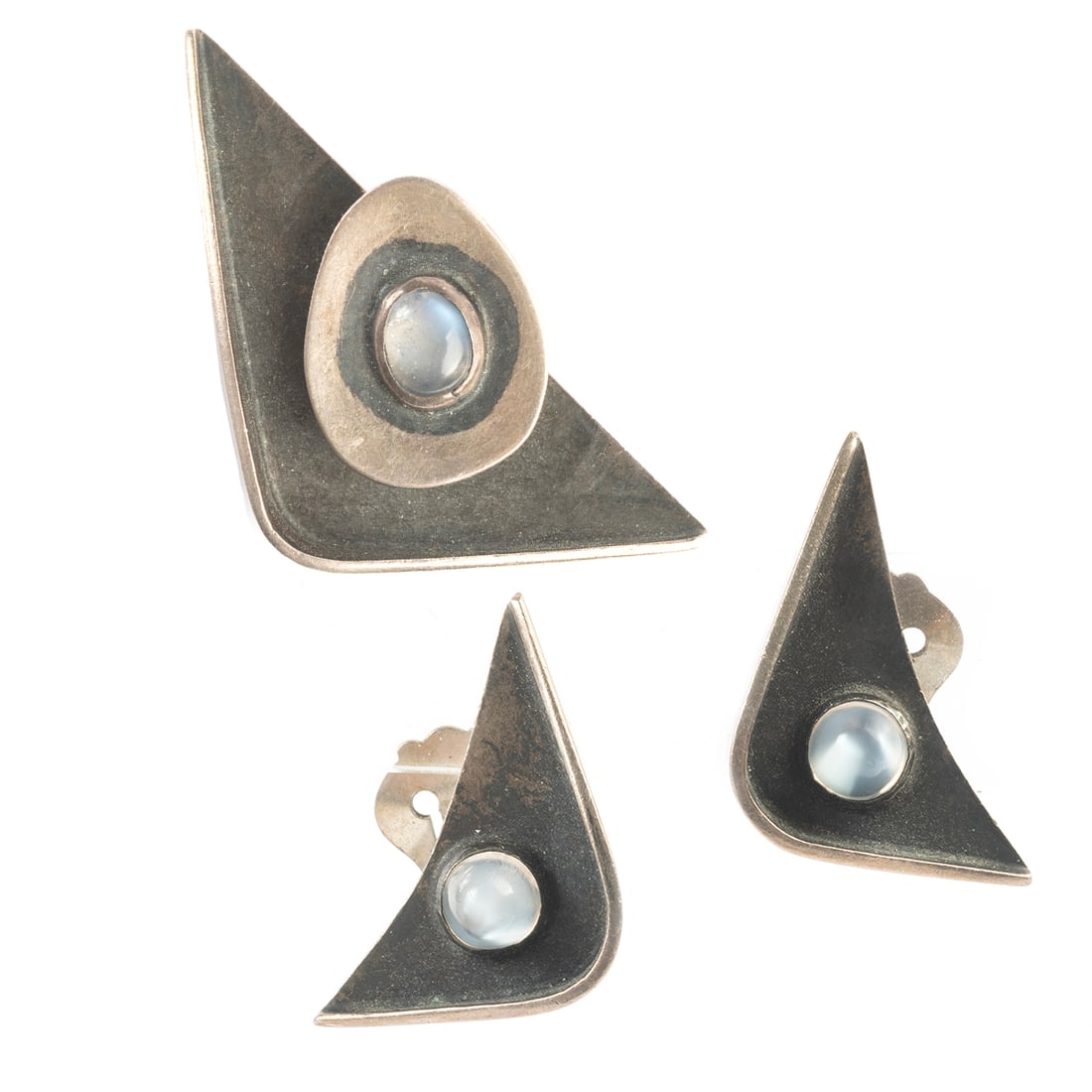 Modernist Ed Wiener Moonstone, Silver Jewelry Suite.: Modernist Ed Wiener Moonstone, Sterling Silver Jewelry Suite. Including one oval shaped moonstone cabochon, sterling silver triangular brooch measuring approximately 50 x 25 mm together with a matchin