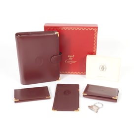 Five Cartier Burgundy Leather Accessories