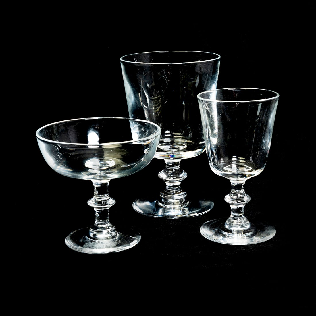 Collection of Steuben Glass Stemware: Collection of Steuben Glass Stemware. Six white wine, fourteen water, twelve champagne coupes, all blown molded with knops to stems and with straight sides but for the coupes. Most of the items inscri