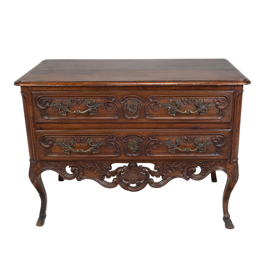 Provincial Louis XV Carved Fruitwood Commode: Provincial Louis XV Carved Fruitwood Commode. Rounded rectangular top overcast above two drawers carved with low relief scrolls and brackets enclosing the cast gilt-bronze handles, above an elaborate
