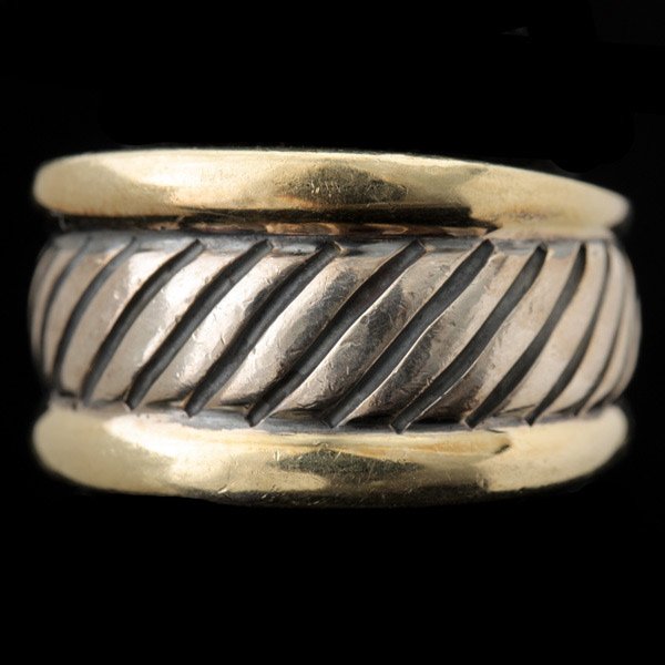DAVID YURMAN 14K YELLOW GOLD, STERLING SILVER RING: DAVID YURMAN 14K YELLOW GOLD, STERLING SILVER RING. Designed as a textured sterling silver band, bordered in 14k yellow gold bands. Size 7, 6.7 dwts