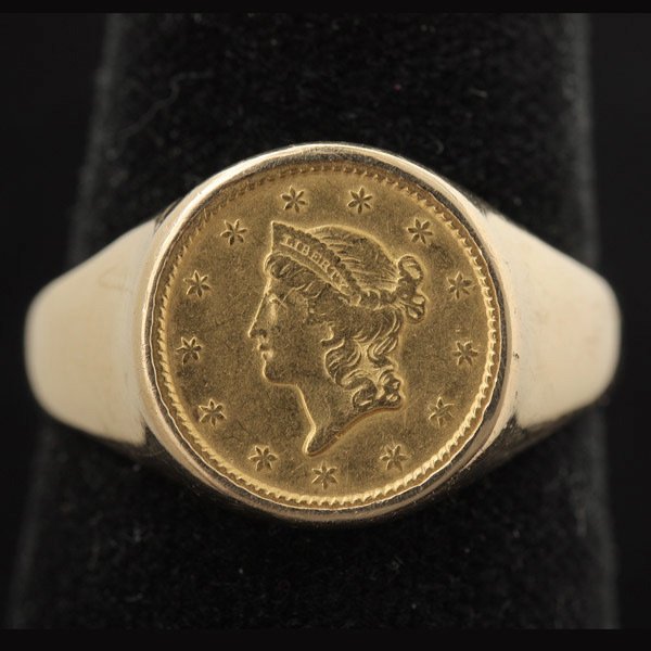US GOLD COIN, 14K YELLOW GOLD RING.: U.S. GOLD COIN, 14K YELLOW GOLD RING. Featuring one U.S. one dollar gold coin, dated 1851, set in a 14k yellow gold mounting. Signed Timothy Fidge, T.F. Size 10 1/2, 4.4 dwts