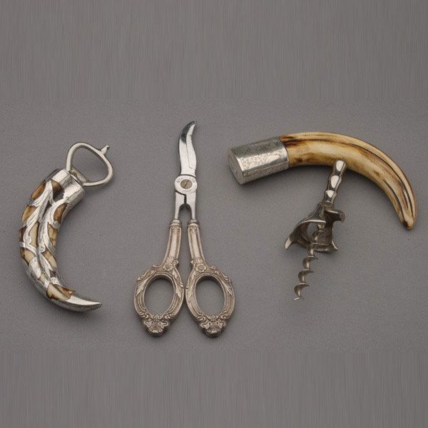 Two Sterling Overlay or Mounted Bar Implements: Two Sterling Overlay or Mounted Bar Implements: a bottle opener and a cork screw both fashioned with a horn volute; together with a pair of Italian grape shears (3) {Length of shears 7 inches}