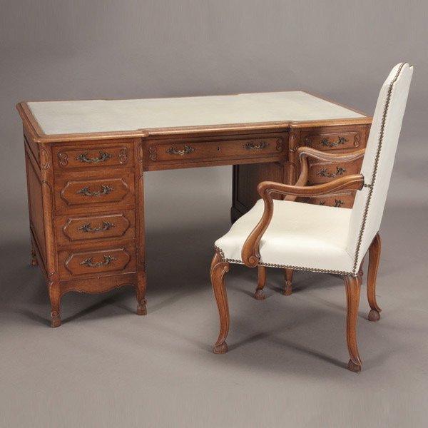 French Provincial Kneehole Desk and Fauteuil: French Provincial Kneehole Desk and Fauteuil; desk inset with ivory leather writing service and Spanish feet; the chair with brass bosses {Dimensions 30 x 55 1/2 x 29 1/2 inches}