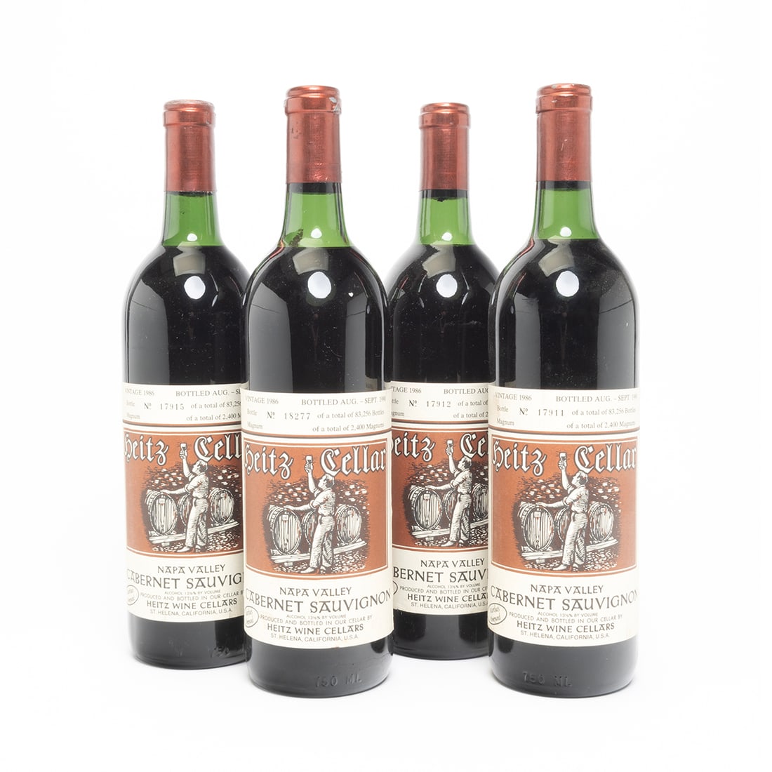 Four Bottles 1986 Heitz Cellars Cabernet Sauvignon Wine: Four Bottles 1986 Heitz Cellars Cabernet Sauvignon Wine. Bottled in 1990, with bottle numbers 18277, 17911, 17912, and 17915 out of 83, 256 bottles. Napa, California. 750 ml. Condition: Labels and cap