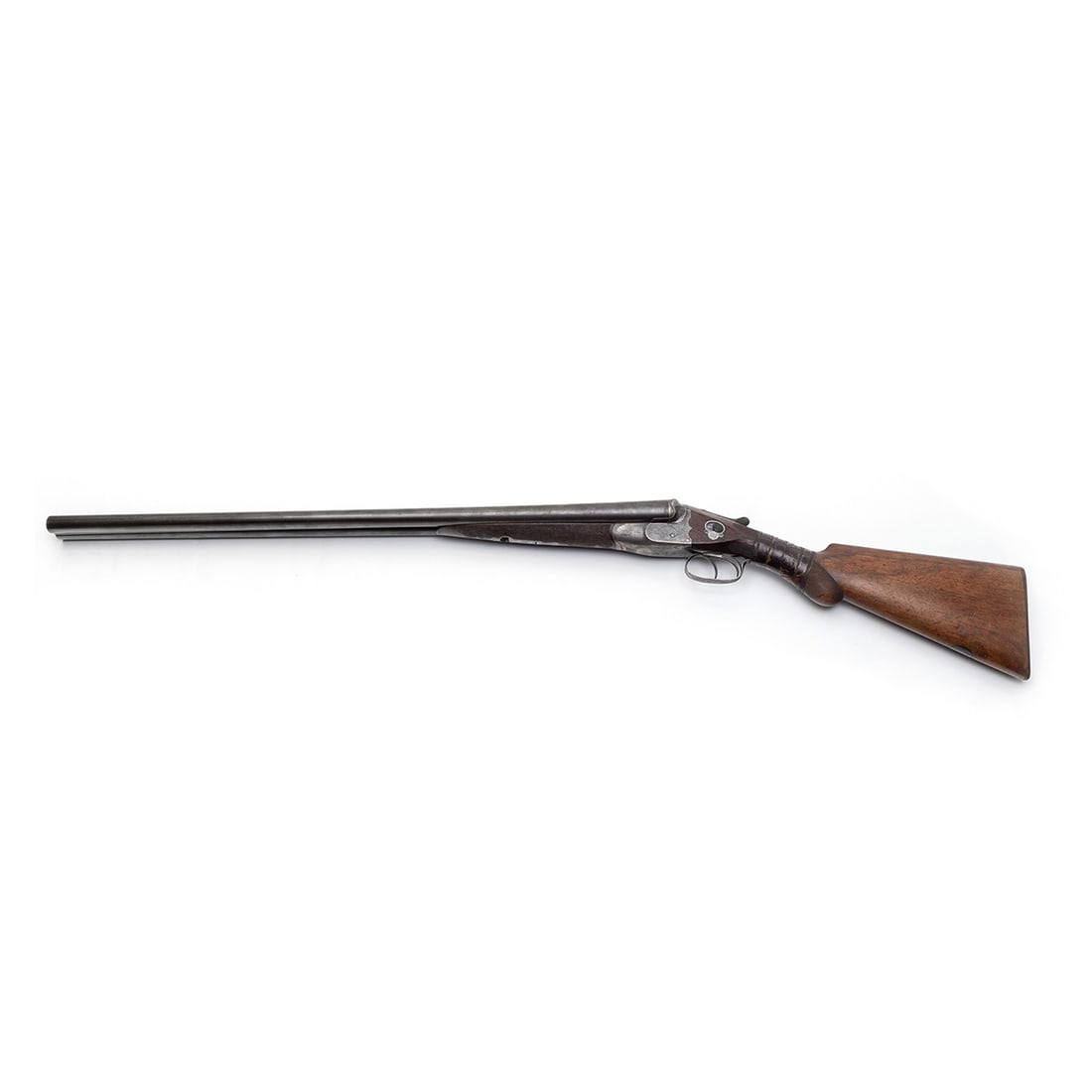 W.W. Greener Engraved Double Barrel Shotgun: W.W. Greener Engraved Double Barrel Shotgun. Walnut butt and grip, double trigger with safety switch above, engraved floral and foliate decoration to receiver and barrel base; with hard leather case d
