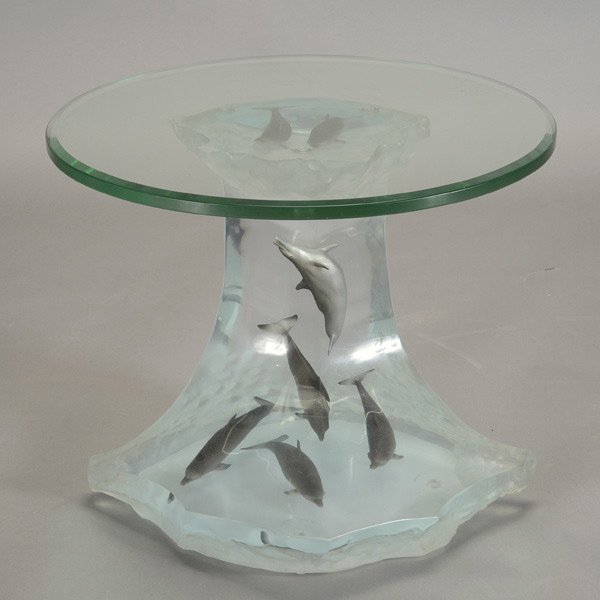 ROBERT WYLAND "Dolphin Wave Table": ROBERT WYLAND (American b.1956) "Dolphin Wave Table" Lucite table with seven composite dolphin inclusions. Base: 21.25 x 23 x 15 inches/ 54 x 58.4 x 38.2 centimeters.Table top: 24 x 24 inches/ 61 x 61