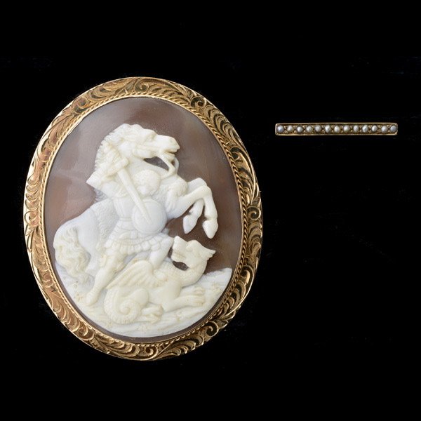 SHELL CAMEO, SEED PEARL, GOLD PENDANT BROOCH.: SHELL CAMEO, SEED PEARL, YELLOW GOLD PENDANT BROOCH. Featuring one oval shell cameo measuring approximately 49 x 40 mm depicting a St. George slaying a dragon, framed in a 14k yellow gold mounting. Ac
