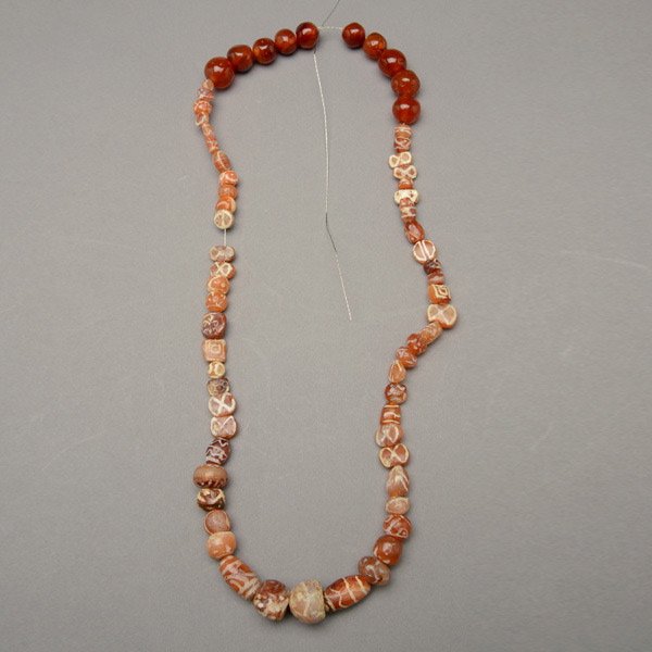 CARNELIAN BEADS.: CARNELIAN BEADS. Including a strand of etched and non-etched carnelian beads.
