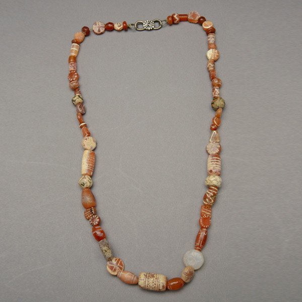 CARNELIAN BEADS.: CARNELIAN BEADS. Including a strand of etched and non-etched carnelian beads.
