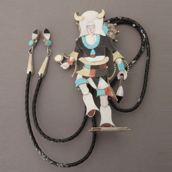MULTI-STONE, INLAY, SILVER BOLO TIE.*: NATIVE AMERICAN MULTI-STONE, INLAY, SILVER BOLO TIE.* Featuring a native dancer inlaid with mother-of-pearl, turquoise, jet, spiny oyster shell and coral measuring approximately 5 1/2 x 3 inches with