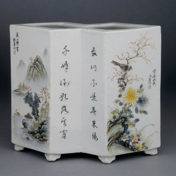 An Enameled Porcelain Brush Pot: An Enameled Porcelain Brush Pot, of double lozenge form painted to the exterior with landscapes, trees, flowers and animals alternating with panels of calligraphy, a mark to the base {Width: 6 3/4 inc