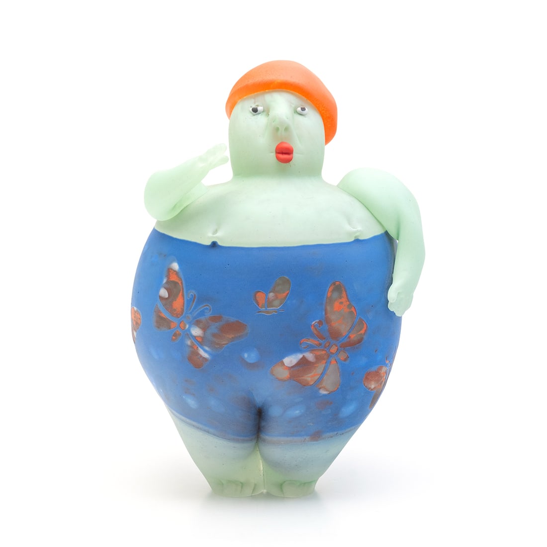 Giampaolo Amoruso Glass Puppet Figure: Giampaolo Amoruso Glass Puppet Figure. Giampaolo Amoruso (Belgian, B. 1961); pale green glass figure with blue butterfly pattern shorts and orange hat. Signed to rear. {Approximate dimensions: 9" high