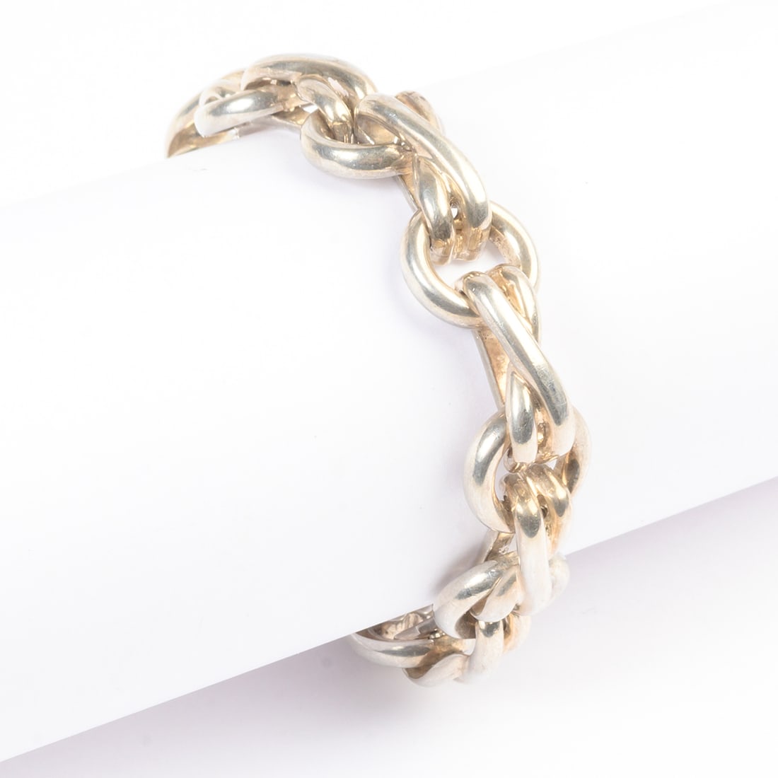 Tiffany & Co. Paloma Picasso Sterling Silver Bracelet.: Tiffany & Co. Paloma Picasso Sterling Silver Bracelet. The sterling silver eternity knot motif and circle link measuring approximately 13 mm in width, completed by a fold over clasp, forming a 6 3/4 i