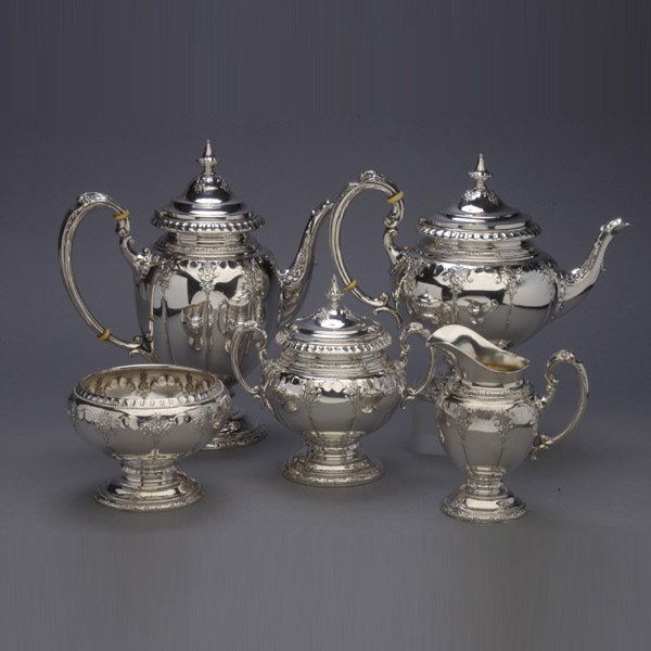 Towle Windsor Rose Sterling Tea Service: Towle Sterling Five Piece Tea Service in the Windsor Rose Pattern. Each piece of paneled melon form headed by a shell band interspersed with floral sprays on a pedestal foot; comprising a coffee pot;