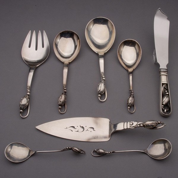 G.Jensen Sterling Pieces in the Blossom Patt 8: Group of Georg Jensen Sterling Serving Pieces in the Blossom Pattern. Each hand wrought piece cast with entwining blossom tendril; comprising a graduated pair of serving spoons (length 7 and 8 inches)