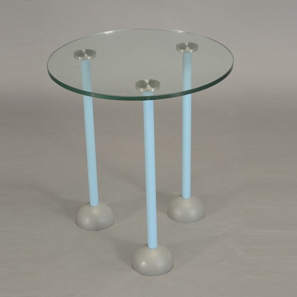 Glass Top Side Table: Glass Top Side Table. Glass top side table Memphis 1987, Aqua enameled legs with castors. Date and item number stamped on bottom. Dimensions: 19 inches in diameter, 21 inches in height.