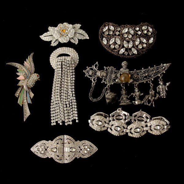 COLLECTION OF COSTUME JEWELRY.: COLLECTION OF COSTUME JEWELRY. Including a rhinestone Coro Duette brooch measuring approximately 3 1/2 x 1 1/4 inches; one metal "Thief of Baghdad" metal sword pin measuring approximately 4 1/2 inches