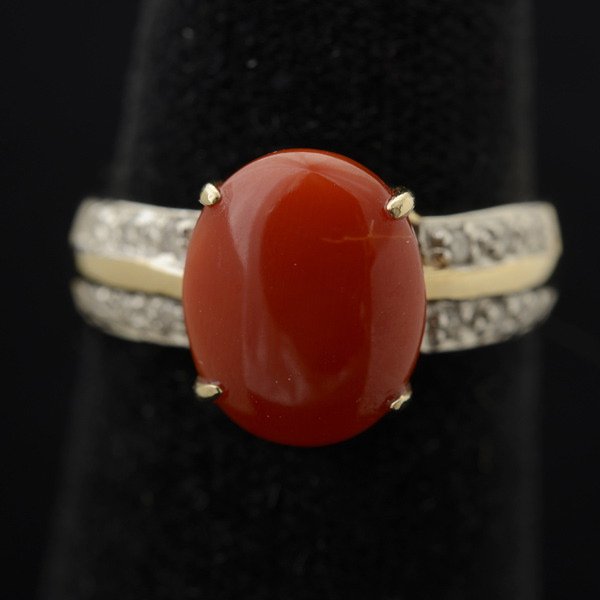 *CORAL, DIAMOND, 14K YELLOW GOLD RING.: *CORAL, DIAMOND, 14K YELLOW GOLD RING. Featuring one oval coral cabochon, accented by six round-cut diamonds weighing a total of approximately 0.05 ct., set in a 14k yellow gold mounting. Size 6 1/2, 