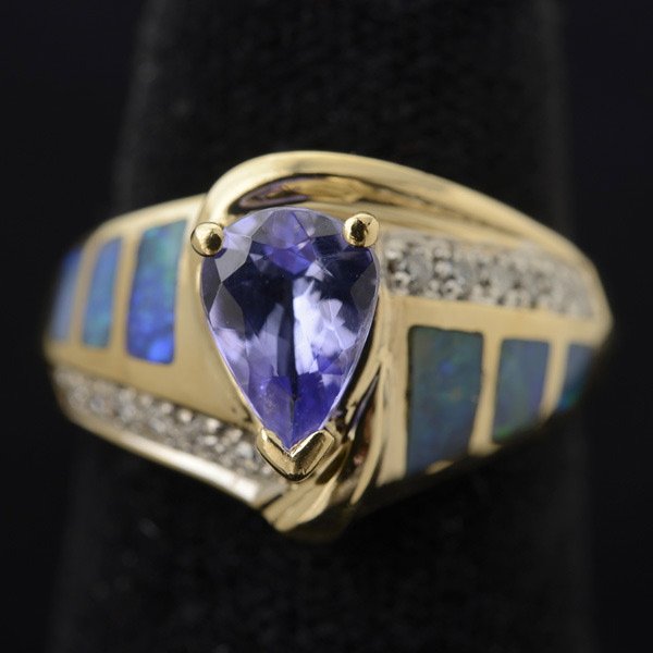 TANZANITE, OPAL, DIAMOND, 14K YELLOW GOLD RING.: TANZANITE, OPAL, DIAMOND, 14K YELLOW GOLD RING. Centering one pear-cut tanzanite weighing approximately 1.00 ct., flanked by twelve full-cut diamonds weighing a total of approximately 0.25 ct., furthe