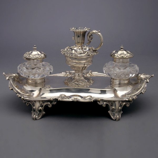 Henry Wilkinson Silver Plate Cut Glass Desk Set: Victorian Sheffield Plate Encrier with Twin Cut Glass Ink Pots and a Chamber Stick with Snuffer, Henry Wilkinson & Co., cast in the Rococo taste with a cartouche on the tray inscribed "The Rev Stephen