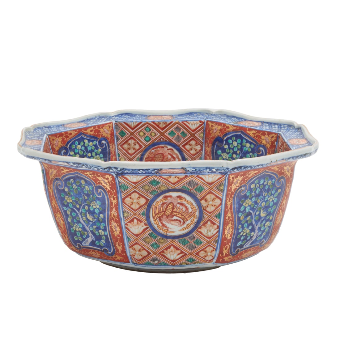 A Japanese Imari Octagonal Porcelain Bowl: A Japanese Imari Octagonal Porcelain Bowl. Decorated with peonies at the center and alternating reserves of mythical creatures, birds, and flower patterns. Meiji Period. {Diameter: 14 1/2 inches (35.5