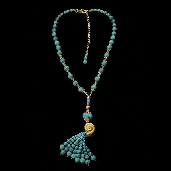 TURQUOISE, SILVER VERMEIL NECKLACE.: TURQUOISE, SILVER VERMEIL NECKLACE. Featuring a silver vermeil shell spilling a tassel of graduated turquoise beads ranging in size from approximately 3 mm to 9 mm, suspended from a graduated turquois