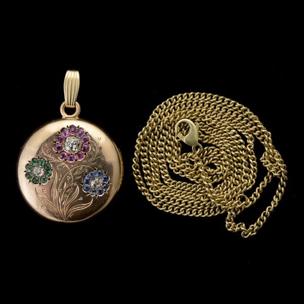 PENDANT LOCKET NECKLACE.: DIAMOND, RUBY, SAPPHIRE, EMERALD, GOLD-FILLED, 14K YELLOW GOLD, METAL PENDANT LOCKET NECKLACE. The gold-filled locket pendant measuring approximately 28 mm features a flower motif, accented by thirty 