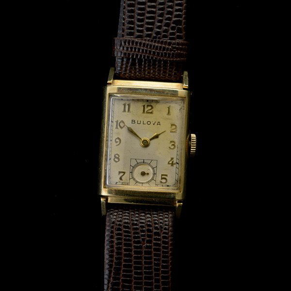 BULOVA 14K YELLOW GOLD, LEATHER WRISTWATCH.: BULOVA 14K YELLOW GOLD, LEATHER WRISTWATCH. DIAL: Rectangular, silvered, applied gold tone Arabic numeral hour markers, gold tone diamond hands, sunken subsidiary seconds dial at 6 O'clock, Bulova. MO