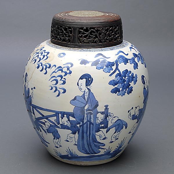 A Blue and White Lidded Ginger Jar: A Blue and White Lidded Ginger Jar, depicting beauties and children at play within a garden setting, reticulated wood lid inset with a carved stone plaque {Height: 9 3/4 inches (24.7 cm)} [Stapled rep