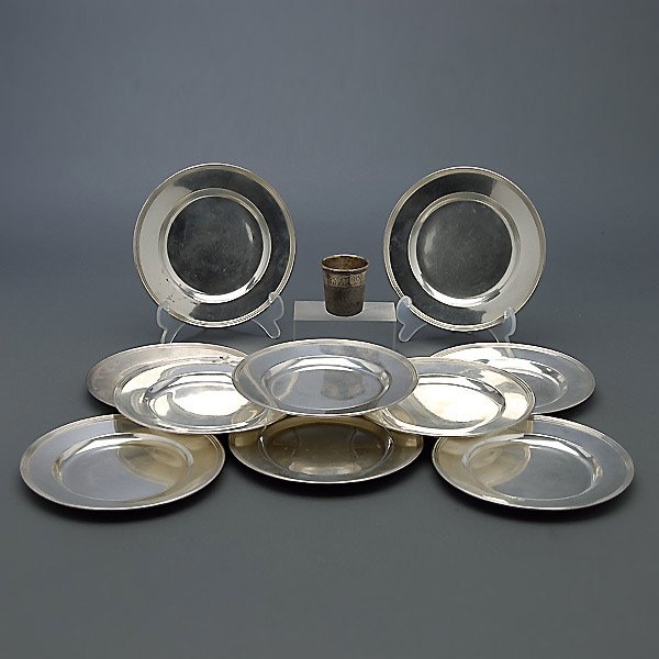 Two Sterling Labels and a Thimble Shot Glass: Set of Eleven International Sterling Bread Plates and a Thimble Shot Glass (12) {Total silver weight 27.11 troy oz; diameter of plates 6 inches}