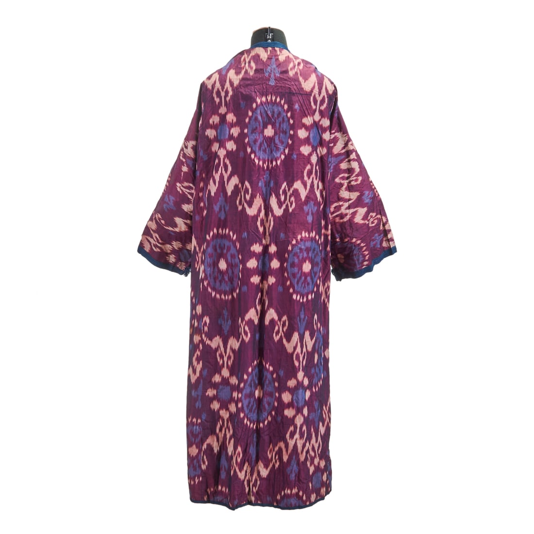 Turkmen Uzbek Silk Ikat Lined Robe Chapan: Turkmen Uzbek Silk Ikat Lined Robe Chapan. Lined with Russian printed cotton and with band of blue knitted trim to fronts and hems. Mid third, 20th Century. {Approximate dimensions: 13 1/2" shoulders;