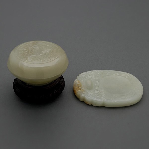 Two Jade Scholar's Implements: Two Jade Scholar's Implements, including a circular covered chrysanthemum box with matching stand, and an inkstone carved with clouds and curling waves {Length of Ink Stone: 3 3/4 inches (9.5 cm)} [Sm