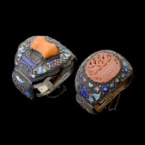 TWO AMBER, CARNELIAN, ENAMEL, SILVER BRACELETS.: COLLECTION OF TWO AMBER, CARNELIAN, ENAMEL, SILVER BRACELETS. Including one carved and pierced carnelian plaque depicting a potted plant, set in a double hinged polychrome, enamel, filigree, silver mo