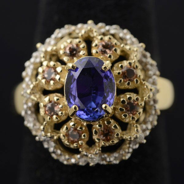 TANZANITE, CITRINE, DIAMOND, 10K GOLD RING.: TANZANITE, CITRINE, DIAMOND, 10K YELLOW & WHITE GOLD RING. Centering one oval-cut tanzanite measuring approximately 7.5 x 6 mm, prong set in a 10k yellow gold mounting featuring eight round cut citrin