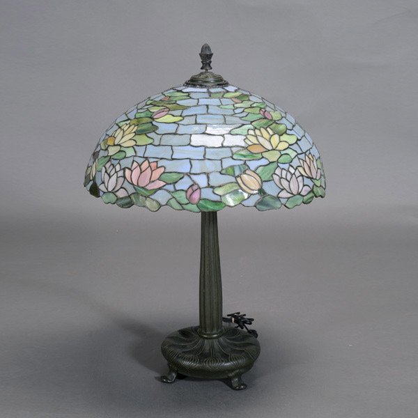 Wilkinson Waterlily Shade Lamp on Onion Bulb Base: Wilkinson Lamp Co. Leaded Glass Waterlily Shade Lamp on a Bronze Base Cast as a Flowering Onion Bulb {Height 29 inches; Diameter of shade 20 1/2 inches} [Approximately 20 tiles with cracks]