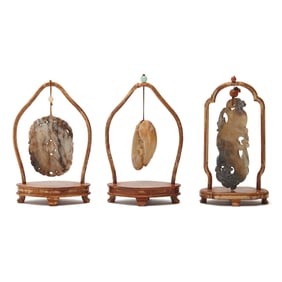 Three Chinese Jade Pendants on Stands.