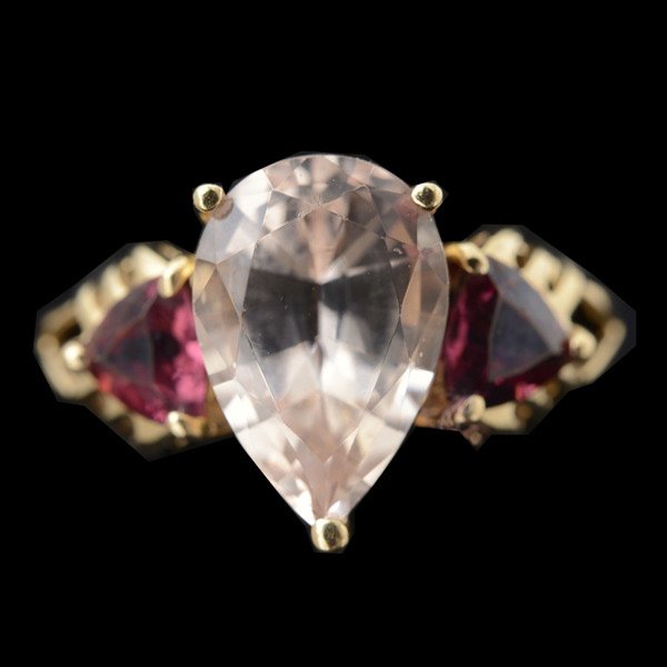 MORGANITE, GARNET, 14K YELLOW GOLD RING.: MORGANITE, GARNET, 14K YELLOW GOLD RING. Centering one pear-shaped morganite weighing approximately 2.60 cts., flanked by two triangular-cut garnets weighing a total of approximately 1.20 cttw., set i