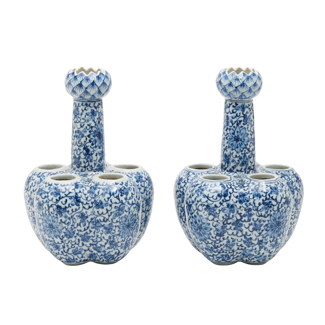 Pair of Chinese Blue and White Flower Vases: Comprising six compressed globular petals surrounding the central elongated tube with a lotus form head, the body painted with blue and white floral and vine patterns. {Height 9 inches}.