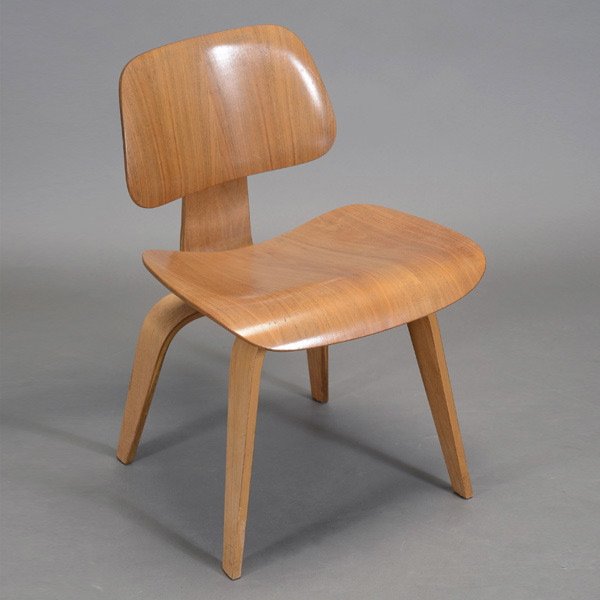 Mid-1950 Eames DCW Chair.: Mid-1950 Eames DCW Chair. Light walnut grain pattern to seat and back. Measures approximately 29 inches in height, 23 inches in depth.