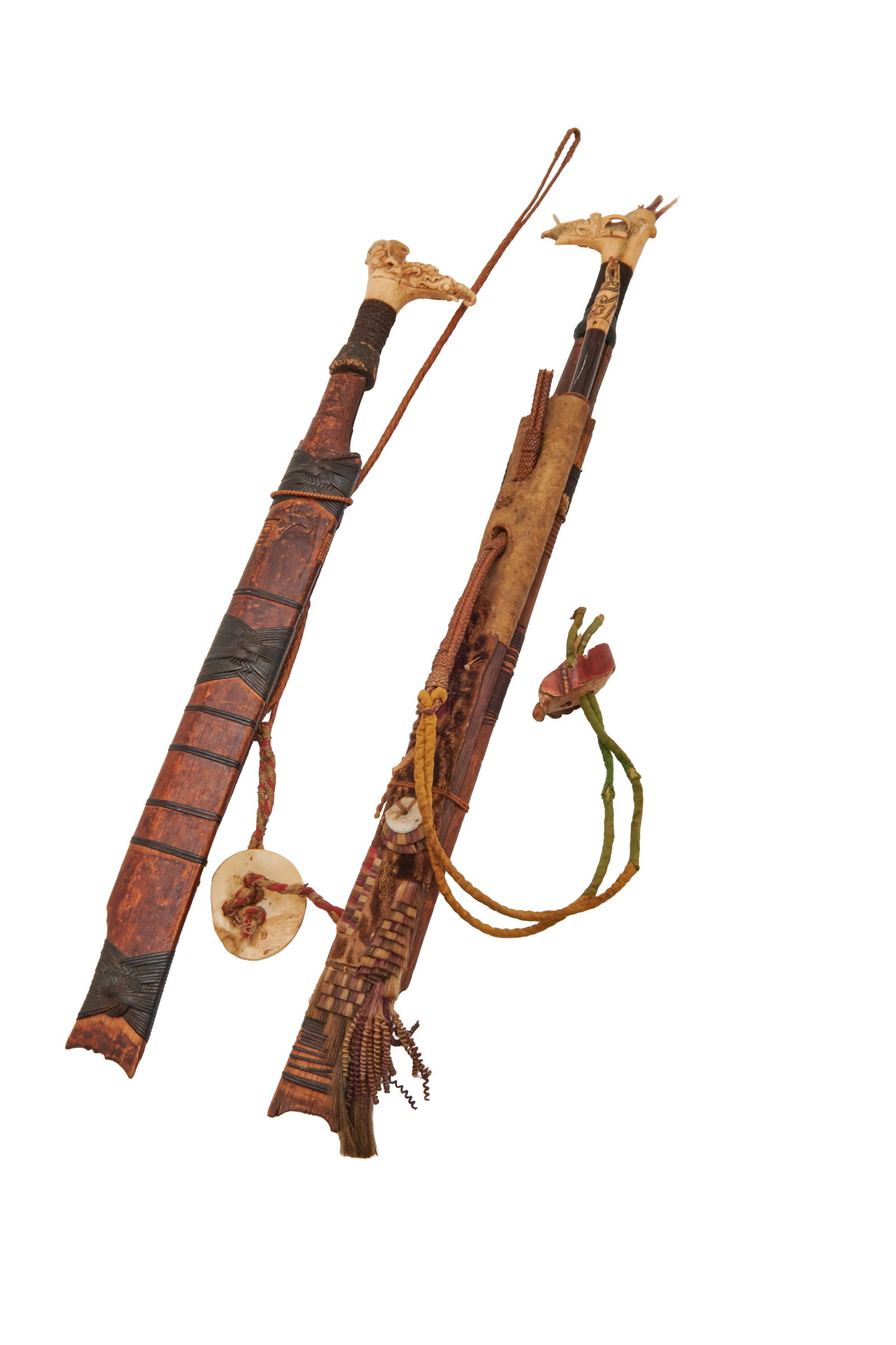 Two Borneo Dayak Mandau Swords with Sheaths: Two Borneo Dayak Mandau Swords with Sheaths.; Comprising example with carved bone pommel, wrapped grip, the blade impressed with indistinct lettering BA..(?), the carved bamboo sheath with woven handl
