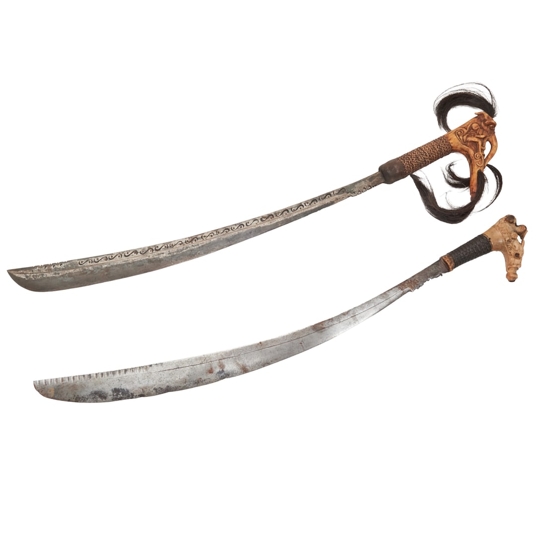 Two Dayak Borneo Mandau Swords: Two Dayak Borneo Mandau Swords.; Both with curved blades bearing incised decoration, carved bone handles one mounted with hair, woven grips.; {Approximate dimensions:; Both similar in size, larger 30
