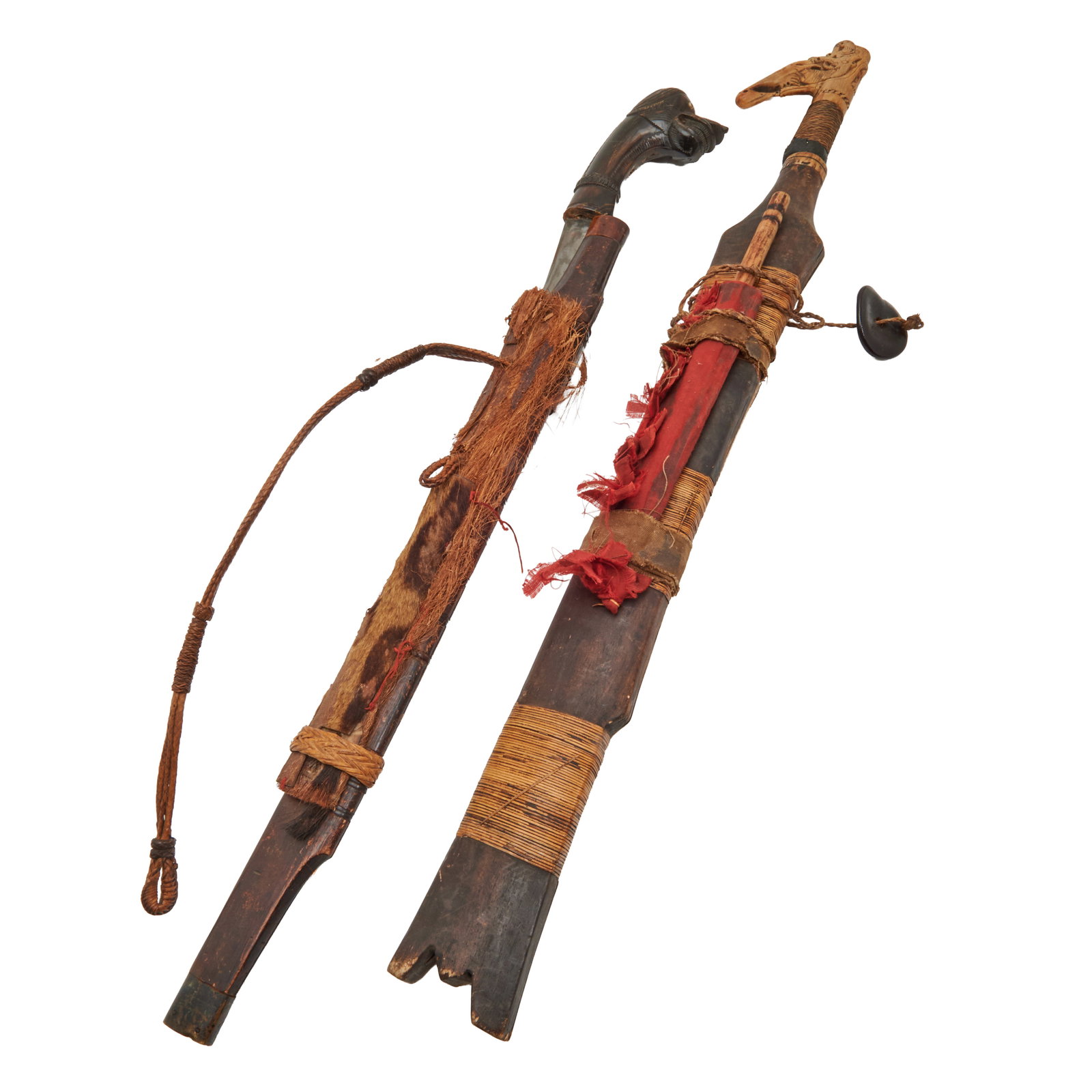 Two Dayak Borneo Mandau Swords Including Damascus Blade: Two Dayak Borneo Mandau Swords Including Damascus Blade.; Comprising Damascus steel fluted blade sword;with figural carved horn handle, carved bamboo sheath with plant fiber and animal fur, woven hand
