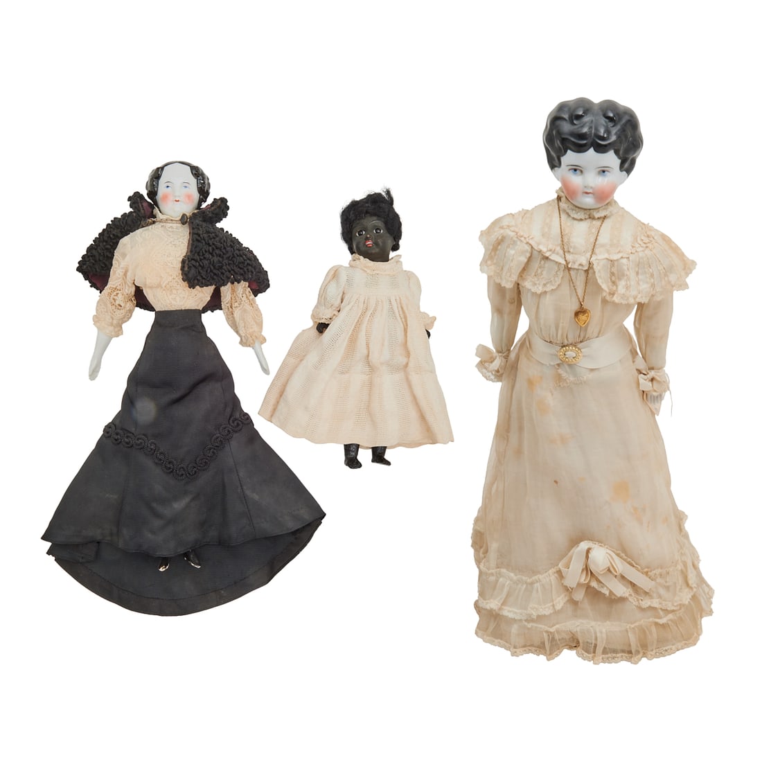 Three Bisque and China Head Dolls Including Afro-European: Three Bisque and China Head Dolls Including Afro-European, comprising a doll with china head, arms and lower legs, in historic dress of 1880 - 1890; a smaller example, in later dress, circa 1890-1915,