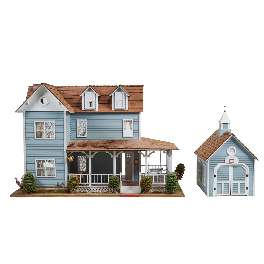 Two Story Clapboard Ell Form Dollhouse: TwoStory Clapboard Ell Form Dollhouse. Comprising two-story grey house with white trim and brown shingle roof, sixrooms plus attic and L-shaped porch with narrow strip of landscaping on three sides, p